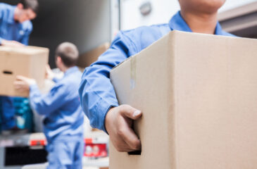 men carrying moving boxes