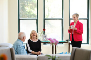 Seniors gather in a meeting area with coffee