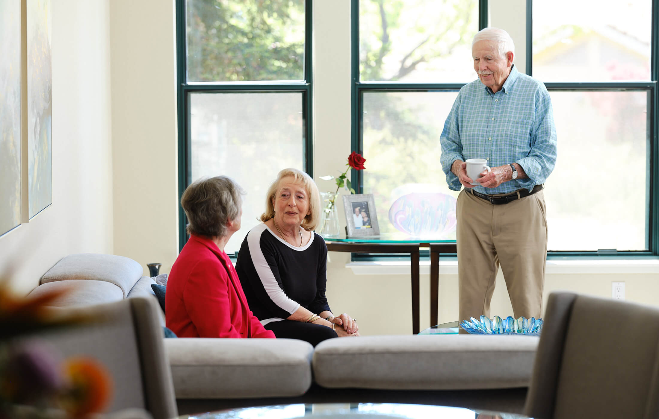 Seniors gather for coffee in their living room