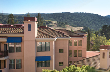 A photo of the senior living apartments and rolling hills behind them