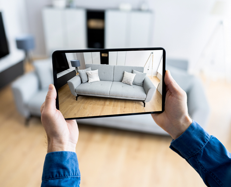 A photo of an tablet taking a photo of a living room couch