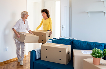 Two women packing and moving