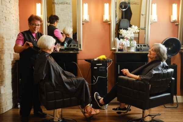 Two women and stylist in the beauty salon
