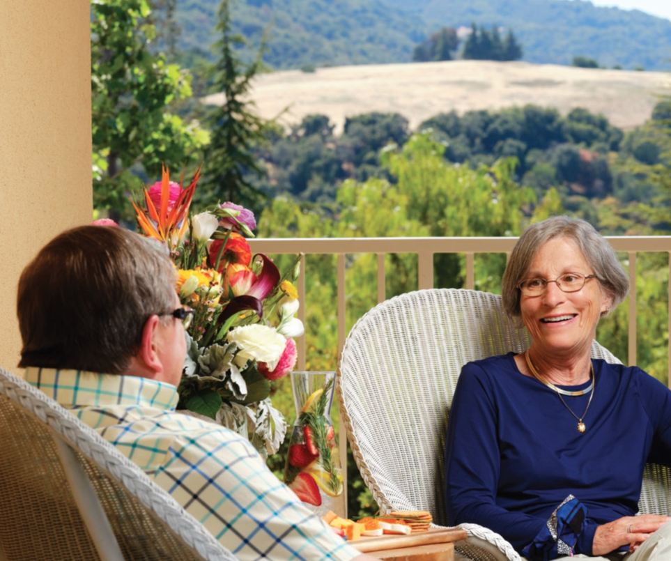 Couple talking on porch