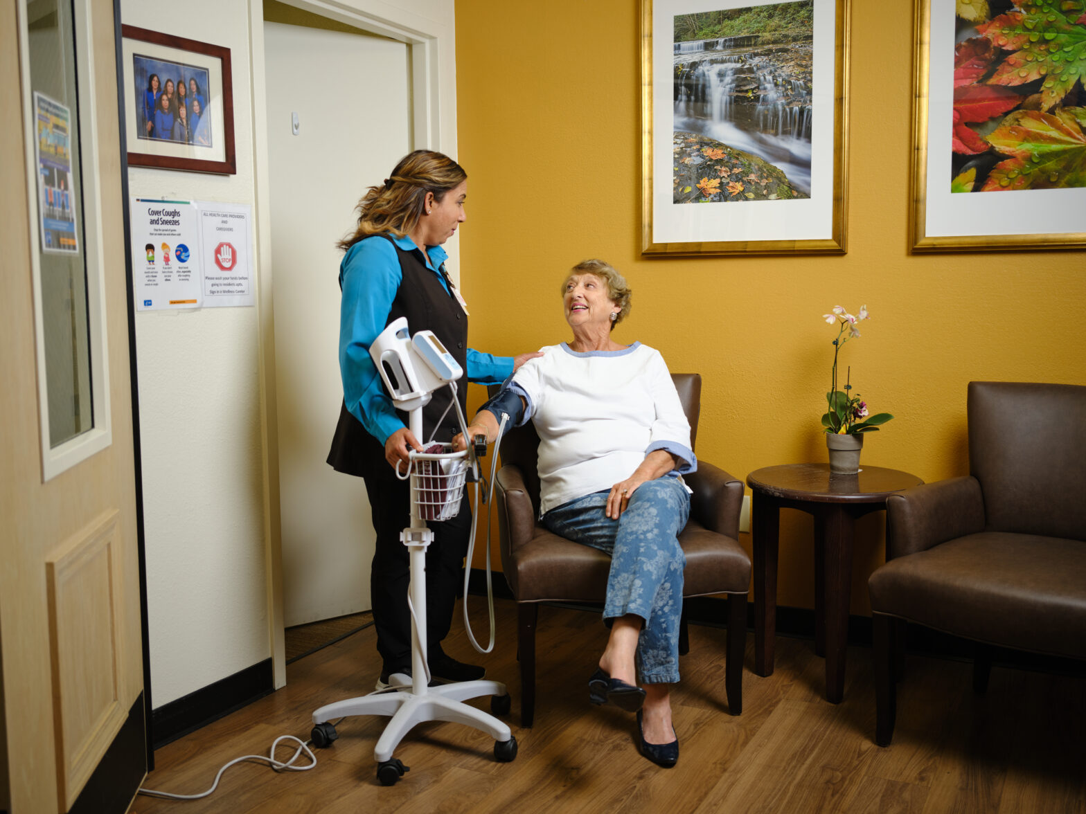 A nurse checks a senior woman's blood pressure